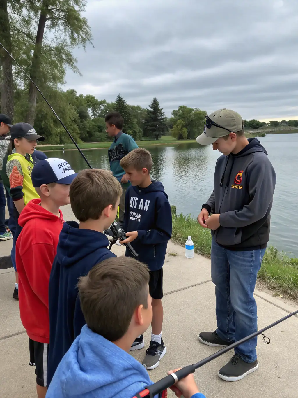 A photo of young anglers participating in a training session on lure fishing techniques, held at a local riverbank, demonstrating hands-on learning and skill development.